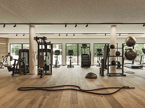 Modernes Fitnessstudio mit Holzfußboden, verschiedenen Trainingsgeräten und großen Fenstern, die Blick ins Grüne bieten. Helle, einladende Atmosphäre.